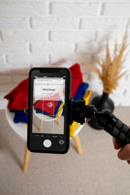 A close-up shot of a smartphone screen displaying the TikTok app, with the focus on a BookTok video showcasing a user enthusiastically reviewing a book. The background has soft lighting and books, creating a cozy, bookish setting.