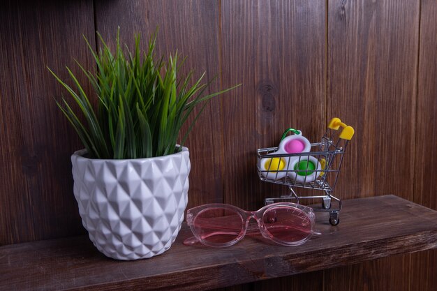 A shelf in a modern bathroom filled with various colorful and elegantly packaged skincare products, body washes, hair masks, and exfoliating tools, showcasing a range of options for an 