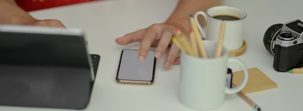 A hand gently turning off notifications on a smartphone, symbolizing the act of regaining control over digital distractions. The background is a peaceful, uncluttered workspace.