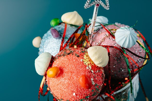 A close-up shot of a variety of whimsical items spilling out of an oversized, brightly colored tote bag, including a miniature disco ball, a single rubber duck, and a pair of novelty sunglasses shaped like bananas. The background is deliberately blurred to keep focus on the items.
