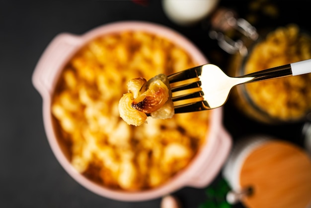 Close-up of truffle mac and cheese bites arranged artfully on a slate board. The bites are golden brown and topped with a sprinkle of fresh parsley and a drizzle of truffle oil.