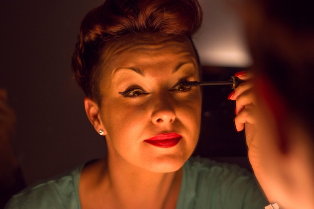 A close-up shot of someone with perfectly laminated brows, showcasing the upward brushed and defined look of the brow hairs. The skin is dewy and glowing, with a subtle highlight on the cheekbones.