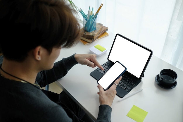 A person sitting at a desk, surrounded by multiple devices (laptop, tablet, smartphone), all displaying different flash sale websites and apps, indicating their search for the best deals.