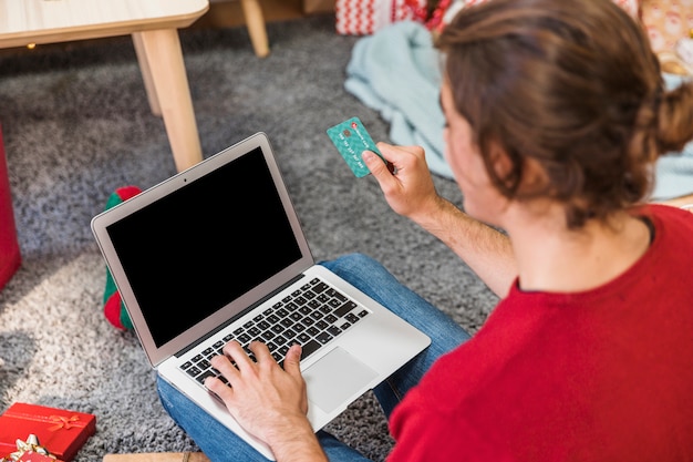 Someone using a laptop, specifically looking at a retail website with a promo code field highlighted. Slightly zoomed in to showcase the promo code field.