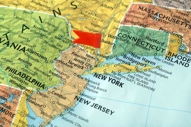 A close-up of a state map of the United States, highlighting different states in various colors, symbolizing the different online sales tax laws in each state. Small magnifying glasses are focused on certain states, indicating research and analysis.