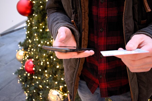 A person using a mobile app specifically designed to manage and track gift cards. The app displays various gift cards with expiration dates prominently visible. The background shows a cozy cafe setting, implying the ease of redeeming the cards during everyday activities.