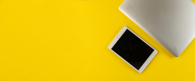 A close-up of an Amazon webpage showing a laptop with a 35% discount highlighted in bright yellow. The background features various other electronics and the Amazon logo is visible in the corner.