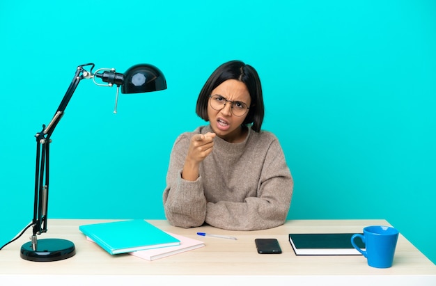 A person sitting at a desk, thoughtfully reviewing the details of a viral challenge on their laptop screen. They have a checklist next to them and are carefully considering the pros and cons before deciding to participate.