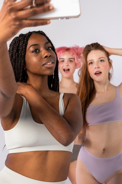 A split image showing three diverse TikTok influencers. On the left is a young woman with bright pink hair dancing in a colorful bedroom. In the middle is a young man doing a hip-hop move in front of a mural. On the right is a non-binary person teaching a dance step in a park.